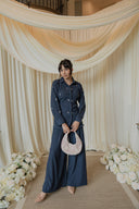 Navy Floral Embroidered Co-Ord Set — full-body front view in decorated interior with pink handbag accessory