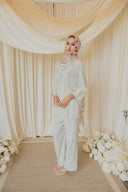 Sage Green Cape Co-Ord Set — three-quarter front view showing cape draped over shoulder, styled with a floral hijab