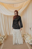 Black Satin Shirt with Wavy Embroidered Hem styled with White Chiffon Skirt with Black Floral Print — front view, arms relaxed